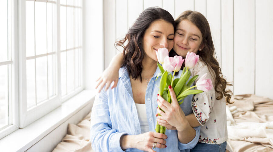 daughter-hugging-mother-with-tulips